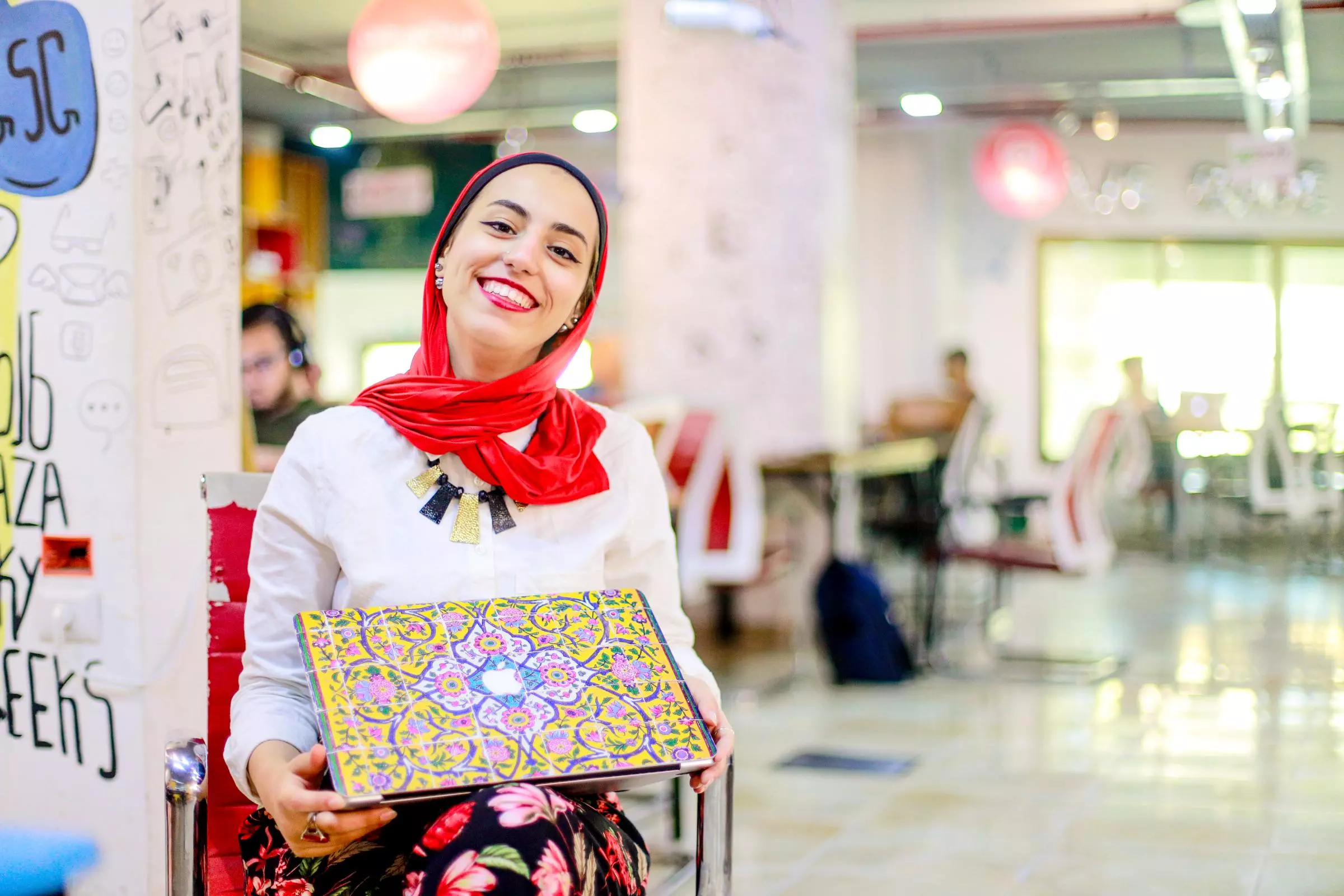 A woman working on a laptop at Gaza Sky Geeks technology center
